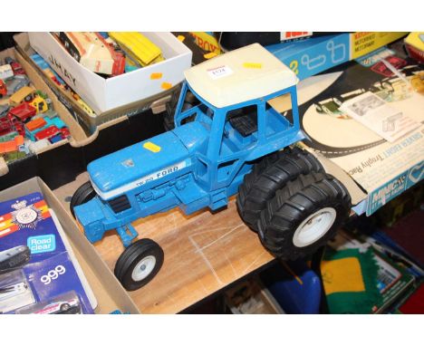 A loose playworn model of a TW20 Ford tractor in blue 