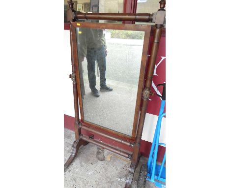 A William IV mahogany cheval mirror, having square cut and turned columns, with urn shaped finials, the rectangular mirror wi