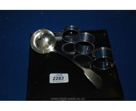 A silver plated Ladle and three Silver Napkin Rings