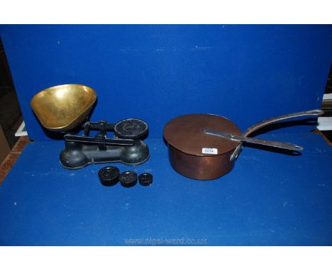 A copper saucepan and lid together with weighing scales with brass dish