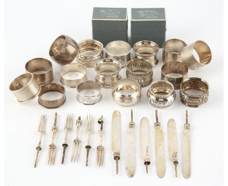 Seventeen various serviette rings, and six tea knife and fork blades ( handles removed ) gross weight 16.3ozt 512gm