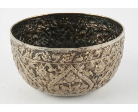 Eastern white metal bowl embossed with figures at prayer among foliate scrolls, base with Chinese character marks, ( tests as
