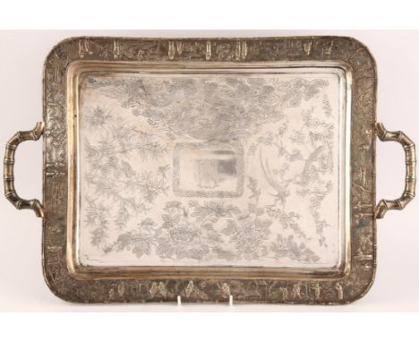 Chinese export silver two handle tray, engraved with two dragons amongst clouds, peonies, and birds on branches, the border c