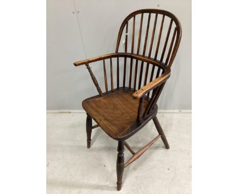 An early 19th century Windsor ash and elm comb back elbow chair, width 58cm, depth 40cm, height 86cm. Condition - fair