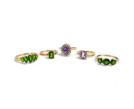 Five gem-set rings, comprising: three rings set with peridots and, one ring set with an amethyst, and one designed as a clust