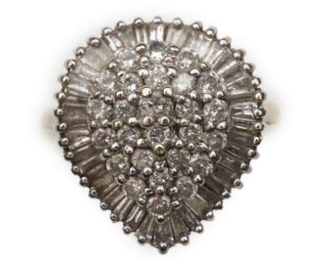 A diamond dress ring, designed as a pear-shaped cluster of brilliant-cut diamonds within a border of baguette diamonds, total
