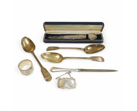 Three assorted George III silver fiddle pattern table spoons, a modern silver spirit label, ‘’Brandy’’, two silver letter ope