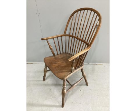 An early 19th century Windsor elm and beech comb back armchair, width 61cm, depth 42cm., height 98cm. Condition - fair