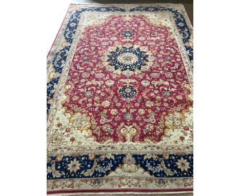A Tabriz burgundy ground carpet, 300 x 200cm. Condition - fair