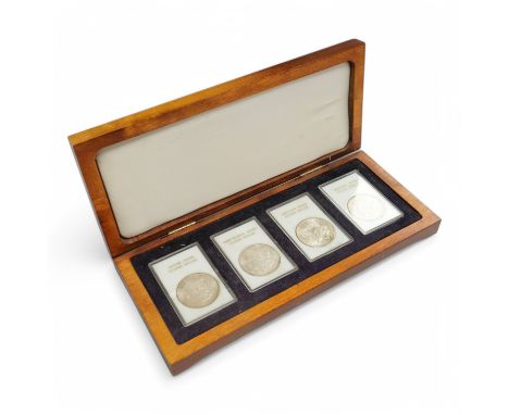 A set of four American silver Morgan coins to include Casino, Continental, Redfield, and Treasury Hoards,Condition - fair