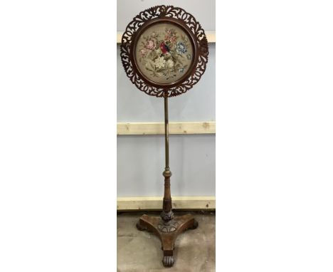A pair of William IV brass and mahogany pole screens with circular tapestry banners, height 134cm. Condition - fair