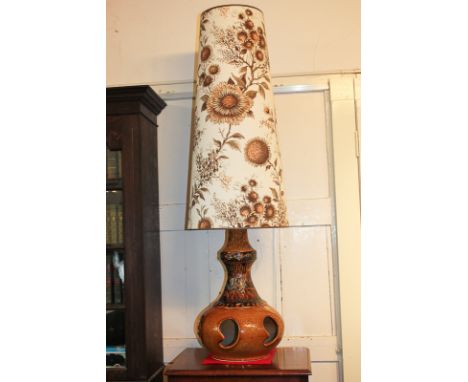 A mid-20th century ceramic table lamp, in honey coloured glaze, with large conical fabric shade, made in West Germany, 126cm 