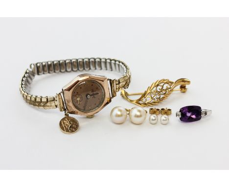 An amethyst pendant in 9ct white gold; a 9ct gold leaf design brooch; two pairs of pearl ear studs; a 9ct gold watch on gilt 