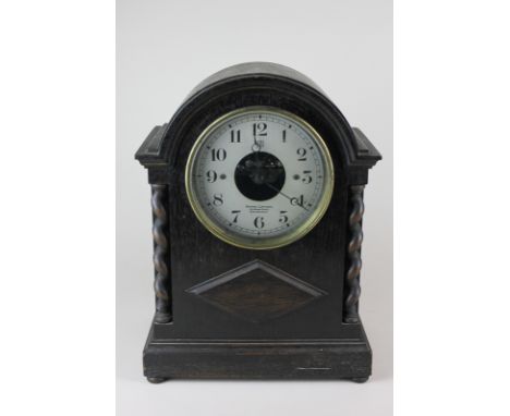An Edwardian Sydney Latimer Scottish Bule mantle clock in oak case with barley twist supports 23cm wide