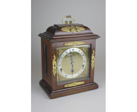 A reproduction gilt metal mounted mantel clock, in the form of a Georgian bracket clock with eight day Westminster chime move