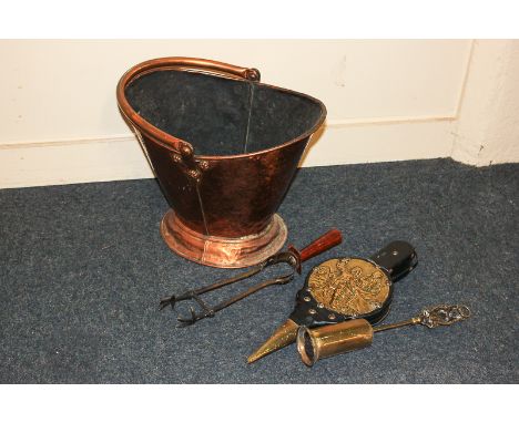 A copper coal bucket and three fire tools
