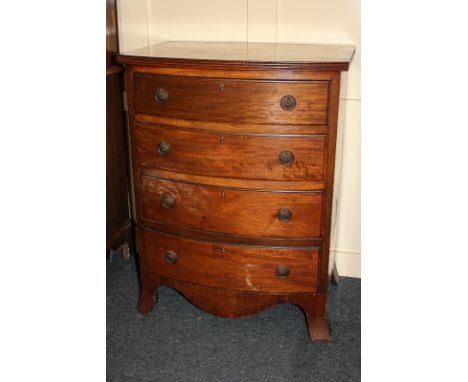 A small mahogany bow front chest of four drawers with drop ring handles, shaped apron, on splayed bracket feet, 61cm