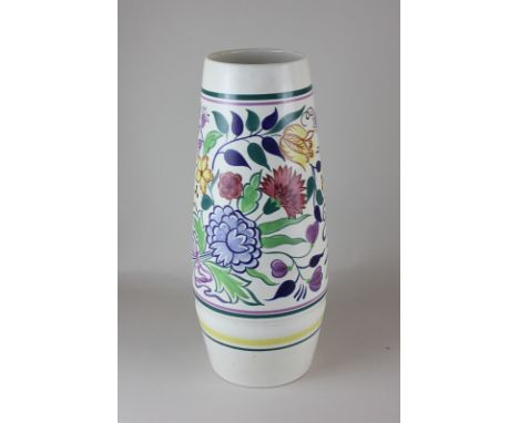 A large Poole Pottery cylindrical vase with brightly coloured floral decoration, 39cm high
