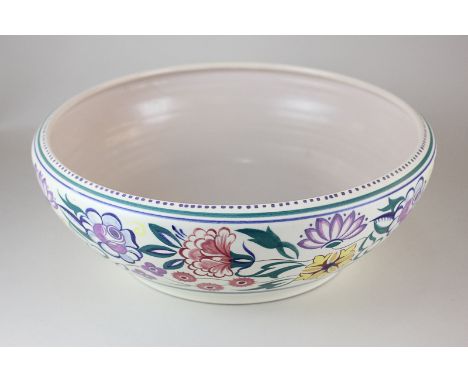 A large Poole Pottery bowl with brightly coloured floral decoration, 33cm diameter