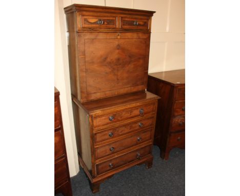 A 20th century walnut secretaire a abattant, with two short drawers over fall front enclosing a fitted interior of cupboard, 