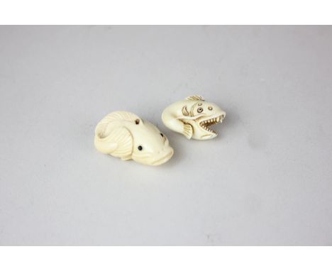 Two late 19th/early 20th century Japanese carved ivory netsuke, in the form of fish, one with gaping mouth and baring teeth, 