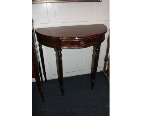 A reproduction mahogany demi-lune side table, shaped centre with drawer, on reeded legs, 83cm