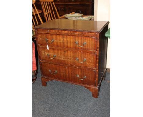 A small mahogany chest of three graduated drawers, 71cm, with brushing slide, on bracket feet