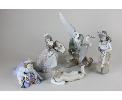 Three Lladro porcelain figures, girl with umbrella, little girl sitting on a large teddy bear, and sleeping child together wi