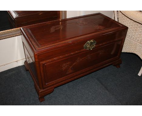 A modern Chinese camphor wood trunk with blossom and bamboo decoration, 93cm