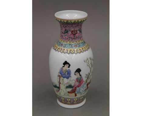 A Chinese famille rose vase decorated with two female scholars in a garden, with square seal mark to base. 20.5 cm high.