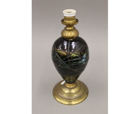 A brass mounted iridescent glass lamp. 31.5 cm high overall.