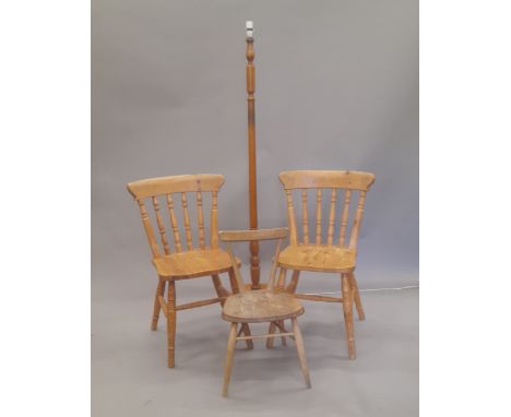 An Ercol elm seated child's chair, two pine kitchen chairs and a standard lamp. 