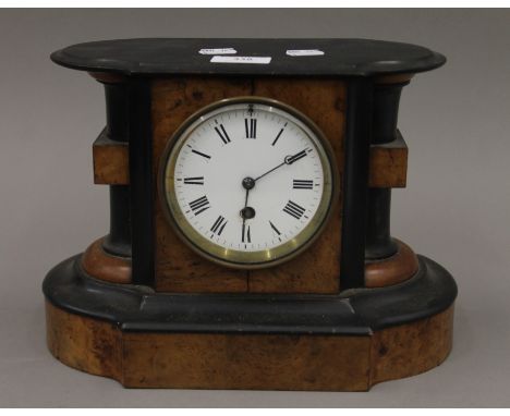 A Victorian walnut mantle clock. 30 cm wide.
