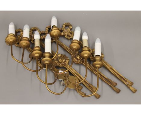 Four gilt wall light fittings. 59 cm high.