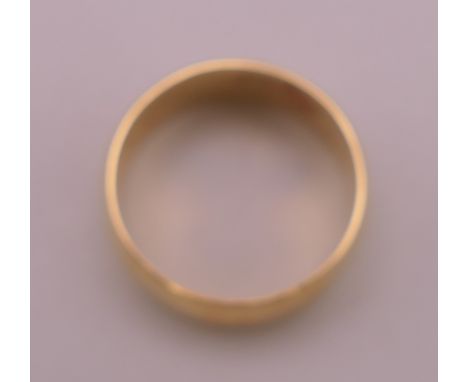 An unmarked gold wedding band, indistinctly inscribed to inner band WENDY 26-???. Ring size L/M. 6.8 grammes.