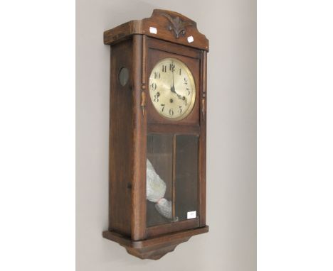 A late 19th/early 20th century oak Vienna wall clock. 77 cm high.