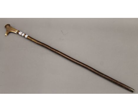 A walking stick, the antler handle set with a whistle. 96 cm long.