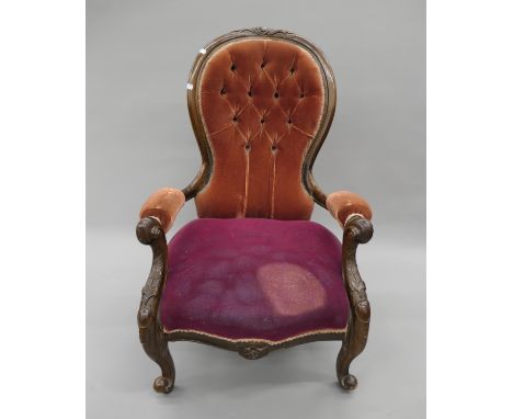 A Victorian upholstered button back open armchair. 66 cm wide.