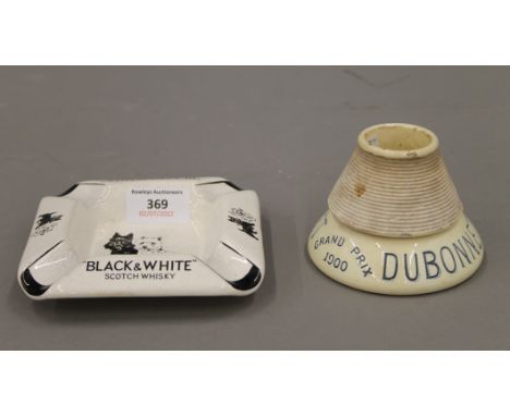 A Black and White Scotch Whisky ashtray and a Dubonnet Grand Prix 1900 table vesta match striker. The latter 7.5 cm high.