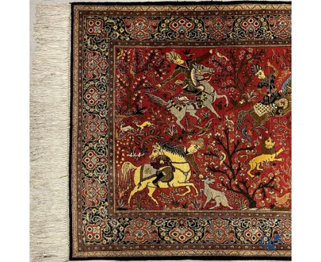 Oriental carpets, a Persian carpet in silk with a scene of hunters on horseback. | 109 x 170 cm.