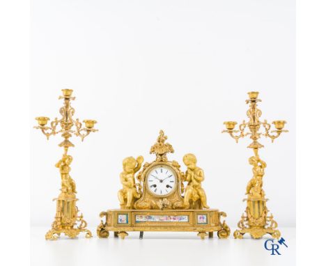 A 3-piece gilded bronze fireplace clockset with Sèvres porcelain. | Clock: 32 x 39 x 12 cm.Candlesticks: Height: 43 cm. | Con