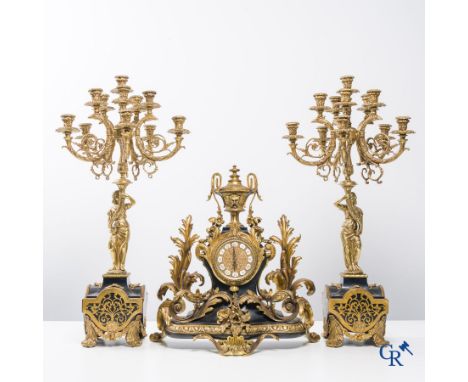 An imposing 3-piece chimney clock set in bronze and Boulle technique. | Clock: 54 x 48 x 24 cm.Height of candlesticks: 80 cm.