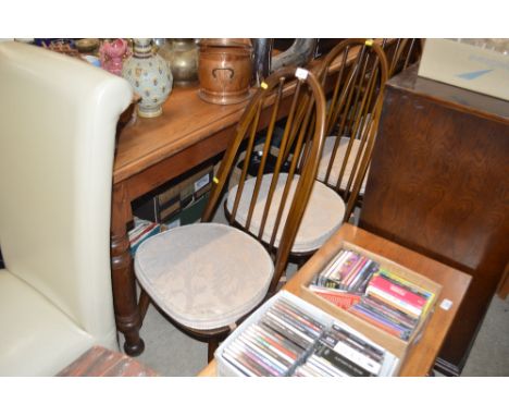 A set of four Ercol stick back dining chairs 