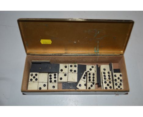 A silver plated box and contents of antique dominoes 