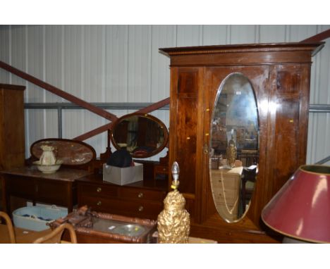 An Edwardian mahogany and inlaid three piece bedroom suite comprising of single door wardrobe, dressing chest, and washstand 