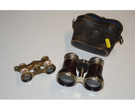 A pair of leather cased opera glasses; and a pair of enamel floral decorated opera glasses AF
