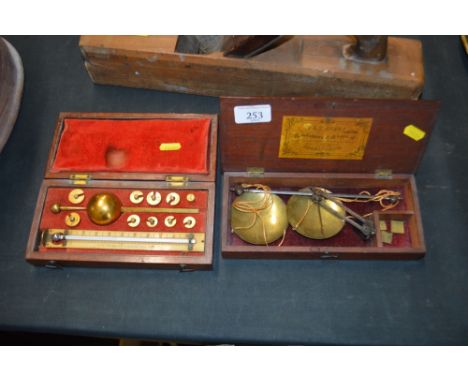 A mahogany cased Sikes hydrometer; and a set of 19th Century scales 