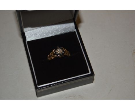 A 9ct gold sapphire and diamond set ring of flower head form 