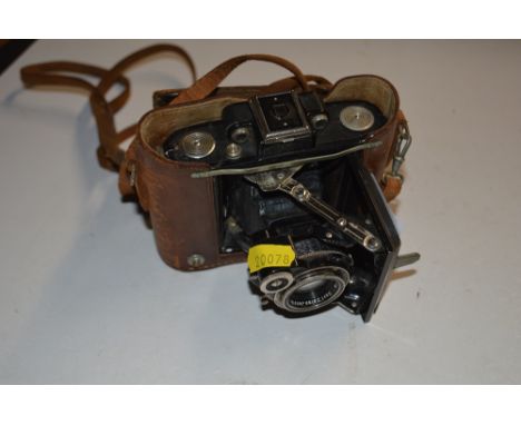 A Zeiss Ikon camera with leather carrying case 