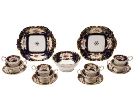 A Coalport Adelaide shape part tea service: enamelled with panels of exotic birds reserved on a royal blue and gold embellish
